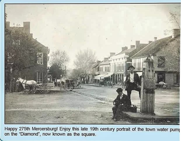 A historical late 19th-century photograph of Mercersburg featuring a water pump and street scene.